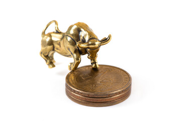 A symbol of wealth, financial optimism on the stock exchange, or greed - a golden bull (calf) and a 1 US dollar coins