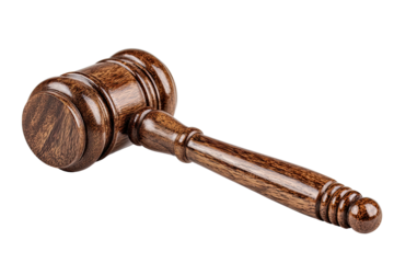 Close-up of a wooden gavel lying diagonally, isolated against a black background