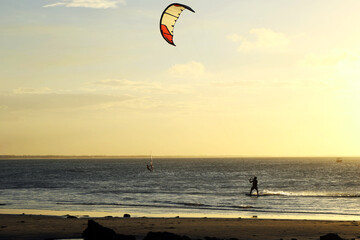 Man practicing kitesurfing in Jericoacoara beach, Brazil in summer sunset time