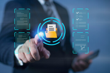 Businessman point at Yellow folder icon in center surrounded by various digital documents on virtual screen, Document management system (DMS) , Concept of data management.