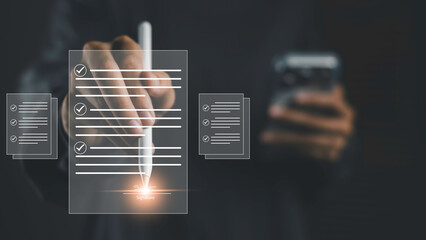 Digital document approval with e-signature. A hand uses a stylus to sign on electronic documents,...