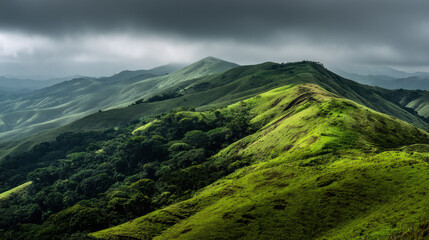 Fototapeta premium Rolling green hills stretch towards a horizon shrouded in dramatic clouds, creating a serene and picturesque landscape perfect for hiking and nature exploration.