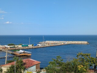 fishing pier juts out into the sea, a view of the sea on a clear day