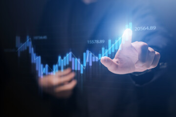 Investing and stock market concept. A businessman touching graph financial data charts for trading forex, stocks, money, and digital assets. business finance, technology, and investment