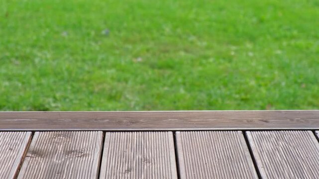 Empty rustic table top with blurred green grass landscape background. Abstract wooden counter. Mockup for promo, text or logo brand. Free space for text. Frame for display. Modern Presentation desk.