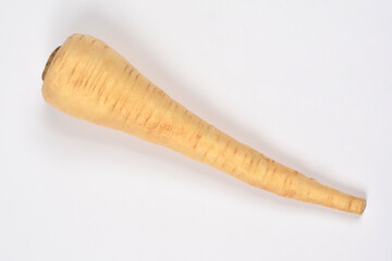 A single, whole raw parsnip, long and tapered with light beige skin, is positioned diagonally on a plain white background