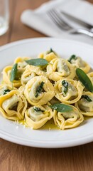 Delicious Tortelloni with Sage Butter Sauce on White Plate.