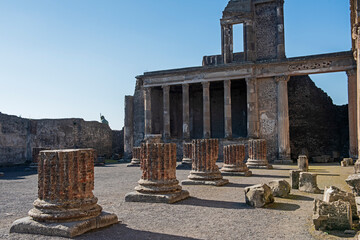 Columns in ancient Roman city temple ruins with blue sky