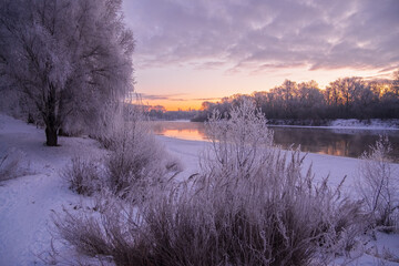 sunrise over the river with frost on trees