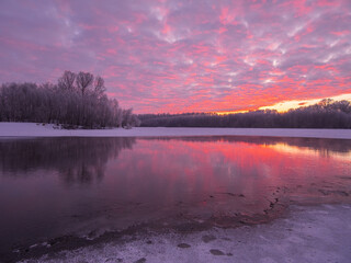 winter sunrise over the frozen lake