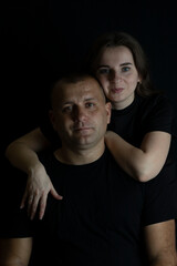 Couple embracing love and intimacy on black background