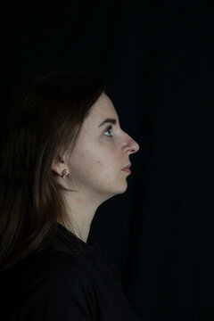 Young woman looking up with pensive expression