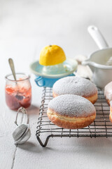 Closeup of sweet and homemade donuts with red jam