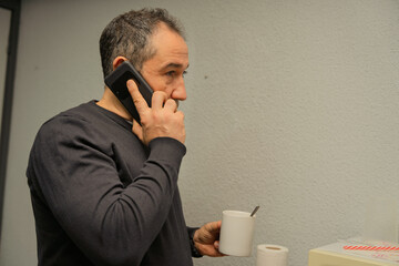 Man talking on phone during coffee break