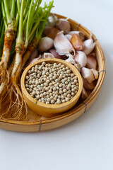 Garlic cloves, coriander roots, and white peppercorns, key ingredients for a classic Thai spice paste