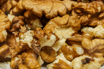 Walnuts arranged in a bowl after being cracked open and prepared for use in cooking