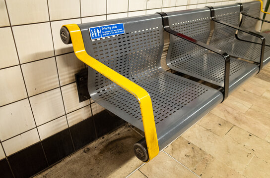 Empty metal bench with priority seating