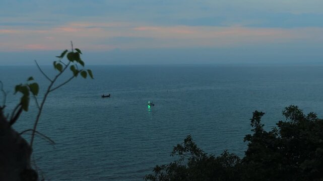 The video background depicts the waterfront, with twilight sky illuminating the riverside community and the lights from houses, reflecting the rural lifestyle of Chanthaburi, Thailand.