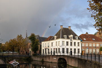 Amersfoort, canal with old city buildings and rainbow and birds. A lucky shot 