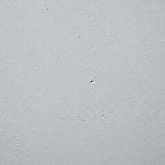 A light grey textured surface background with rough imperfections and stippled pattern