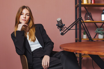 Podcast interview with woman discussing various topics in modern broadcast studio setting