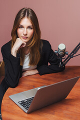 Podcast interview with woman at a desk in a studio setup discussing various topics