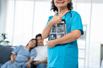 A caring gynecologist provides expert guidance and health care during a pregnancy examination. With ultrasound technology, the doctor offers advice to ensure the well-being of both and her family