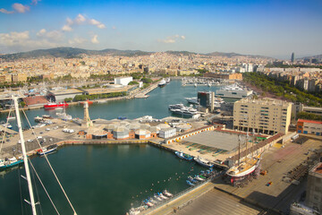Naklejka premium Port and waterfront of Barcelona. View over the city of the harbour, Port Vell, marina and the city in the background, Barcelona, Catalonia, Spain.