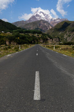Straight Road Leading to the Snowcapped Peak of Mt Kazbegi in the Caucasus mountain range, Georgia