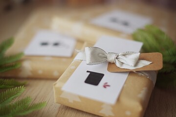 Close-up of a stack of Gift boxes for a homemade Christmas advent calendar with ribbon on a wooden table