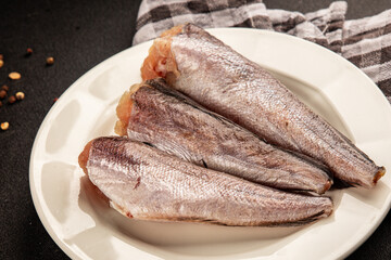 Hake raw fish seafood healthy food main course ingredient appetizer fresh delicious gourmet food table setting rustic food top view copy space pescatarian diet