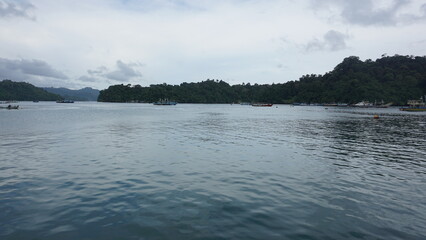 Colorful Fishing Boats Anchored in Calm Waters at Sendang Biru Beach, South Malang, East Java, Indonesia
