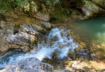 Canyon and mountain river with rapid flow and unusual stone bed in the autumn season