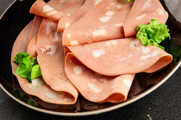Mortadella sausage slices meat food tasty snack fresh delicious gourmet food background on the table rustic food top view copy space