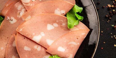 Mortadella sausage slices meat food tasty snack fresh delicious gourmet food background on the...