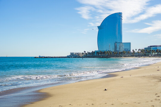 Barcelona, Spain, Europe - Nov 23, 2025: barcelona beach sea wave sand W hotel vela skyscraper modern architecture blue sky panoramic concept of travel tourism luxury