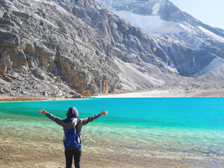 Young woman raising her hands up in the air