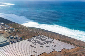 France, Reunion Island, solar energy field near the coastline.