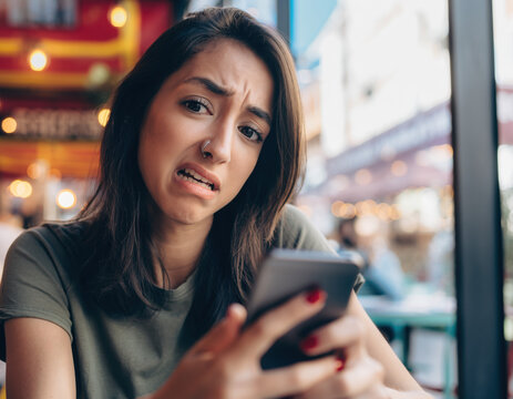 Teenage Girl Giving a Bombastic Side Eye Look of Disgust and Judgment holding Smartphone