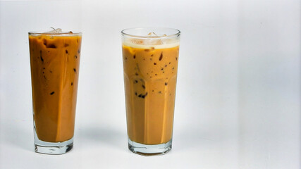 Cold Iced Coffee with Ice Cubes in Tall Glass Isolated on Light Background for Beverage Object and Refreshing Drink Concept