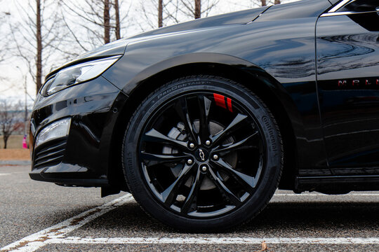 January 3, 2022, Seoul, South Korea - A close-up of the front wheel and tire of a black Chevrolet Malibu sedan.