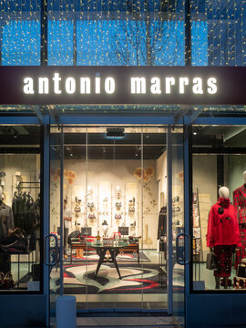 Antonio Marras luxury fashion boutique storefront in Fidenza Village at Christmas, showcasing products and seasonal lights
