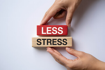Minimalist flat lay of 'LESS STRESS' wooden blocks, symbolizing wellness and mindfulness, supported by hands on a clean white background, perfect for business or self-care themes.