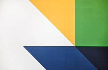 Colorful geometric shape on a background or wallpaper. Abstract of white, blue, yellow and green wall.
