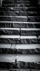 Stone staircase ascending, textured and weathered, shot in grayscale, emphasizing depth and geometric patterns