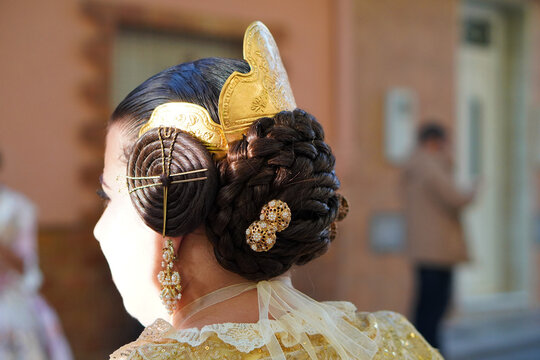 Fallas in Valencia. Faceless image of a typical Fallera hairstyle with its characteristic accessories. Hair comb and jewelry.
