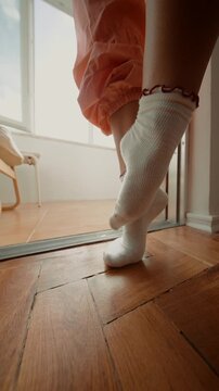 Detailed view of toes pressing into radiant sunlit flooring surface