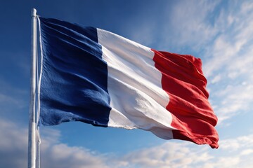National flag of France waving in the wind against a blue sky with soft clouds, symbolizing freedom, unity, and national pride in a vibrant display of colors
