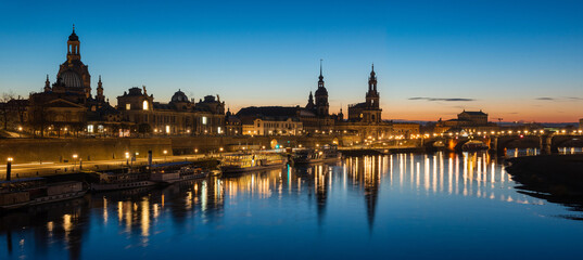  Dresden city skyline at Elbe river and Augustus Bridge at sunset , Dresden, Saxony, Germany. Panoramic evening view of Dresden.