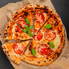 Pizza tomato margarita fast food natural product tasty snack fresh delicious gourmet food background on the table rustic top view copy space